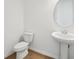 Modern powder room with pedestal sink and neutral finishes at 5714 Cattle Ranch Dr, St Cloud, FL 34771