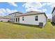 Exterior view of the backyard, highlighting the property's outdoor space and landscaping at 5715 Cattle Ranch Dr, St Cloud, FL 34771