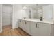 Modern bathroom featuring dual sinks, sleek cabinetry, and a glass-enclosed shower at 5715 Cattle Ranch Dr, St Cloud, FL 34771