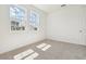 Bright bedroom with carpeted floor and two sunny windows with neighborhood views at 5715 Cattle Ranch Dr, St Cloud, FL 34771