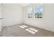 Bright, airy bedroom with carpeted floor and two sunny windows overlooking the neighborhood at 5715 Cattle Ranch Dr, St Cloud, FL 34771