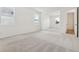 Large bedroom with light-colored carpet, bright windows and attached bathroom entry at 5715 Cattle Ranch Dr, St Cloud, FL 34771