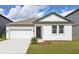 Charming one-story home featuring a two-car garage and manicured front lawn at 5715 Cattle Ranch Dr, Saint Cloud, FL 34771