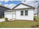 Well-maintained home with lush green lawn, gray trim, and a two-car garage at 5715 Cattle Ranch Dr, Saint Cloud, FL 34771