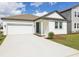 Inviting home with attached garage, green lawn, and modern architectural design at 5715 Cattle Ranch Dr, St Cloud, FL 34771