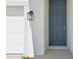Close-up of a contemporary-style front door with modern lantern at 5715 Cattle Ranch Dr, St Cloud, FL 34771