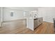 Kitchen island with white quartz countertops and stainless steel dishwasher faces open and airy room at 5715 Cattle Ranch Dr, St Cloud, FL 34771