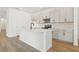 Modern kitchen featuring white cabinets, quartz countertops, and stainless steel appliances at 5715 Cattle Ranch Dr, St Cloud, FL 34771