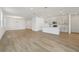Open-concept living space with hardwood floors connecting living, dining and kitchen at 5715 Cattle Ranch Dr, St Cloud, FL 34771