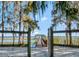 Scenic view of a wooden dock and lake through a rustic wooden fence at 6320 Rocky Point Rd, Lake Wales, FL 33898