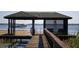 Dock with a view of a plane parked on the water and seating in the gazebo at 6320 Rocky Point Rd, Lake Wales, FL 33898