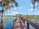 Picturesque view of dock featuring a covered gazebo on a serene lake at 6320 Rocky Point Rd, Lake Wales, FL 33898