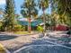 Expansive home exterior featuring unique landscaping, mature trees, and circular driveway at 6320 Rocky Point Rd, Lake Wales, FL 33898