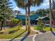 Stately home featuring landscaped grounds with trees, a circular driveway, and plenty of parking at 6320 Rocky Point Rd, Lake Wales, FL 33898