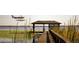 View of a covered boat dock where a plane is taking off from the lake at 6320 Rocky Point Rd, Lake Wales, FL 33898