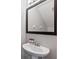 Bathroom with pedestal sink and framed mirror at 8167 Roseville Rd, Davenport, FL 33896