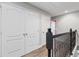 Upstairs hallway with two closets and dark wood railing at 8167 Roseville Rd, Davenport, FL 33896