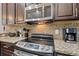Stainless steel appliances and granite countertops in this kitchen at 8167 Roseville Rd, Davenport, FL 33896