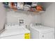 Laundry room with washer and dryer, and overhead shelving at 8167 Roseville Rd, Davenport, FL 33896