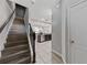 Elegant staircase with dark wood steps and wrought iron railing at 8167 Roseville Rd, Davenport, FL 33896
