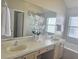 Bathroom with double sinks, vanity, tub, and large mirror creating a bright and functional space at 12859 Enclave Dr, Orlando, FL 32837