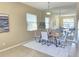 Inviting dining room features a modern table set, mirror, and plant providing a cozy ambiance at 12859 Enclave Dr, Orlando, FL 32837