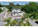 New construction featuring white exterior with black roof amidst lush greenery in a neighborhood setting at 1309 Errol Green Ct, Apopka, FL 32712