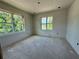 An unfinished bedroom featuring drywall walls, two windows, and flooring, providing ample natural light at 1309 Errol Green Ct, Apopka, FL 32712