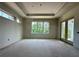 Unfinished room with drywall, a tray ceiling, and multiple windows with natural light at 1309 Errol Green Ct, Apopka, FL 32712