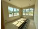 A bright, unfinished bedroom with large windows showcasing neighborhood views and abundant natural light at 1309 Errol Green Ct, Apopka, FL 32712