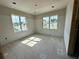 Bedroom with two bright windows, offering plenty of natural light and neighborhood views at 1309 Errol Green Ct, Apopka, FL 32712