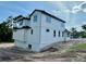 View of a newly constructed two-story home featuring bright white siding and a black tile roof, in progress at 1309 Errol Green Ct, Apopka, FL 32712
