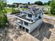 Two-story new construction home with black tile roof, bright white siding, and spacious balcony ready for customization at 1309 Errol Green Ct, Apopka, FL 32712