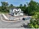 A two-story home with black windows, construction materials and equipment on the property at 1309 Errol Green Ct, Apopka, FL 32712