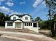 Newly constructed two-story home featuring a modern design, large windows, and a covered porch at 1309 Errol Green Ct, Apopka, FL 32712