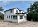 This exterior view shows a two-story white house under construction and a sandy lot at 1309 Errol Green Ct, Apopka, FL 32712