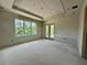 Bright room featuring drywall walls, a tray ceiling, a window with natural light and exterior door at 1309 Errol Green Ct, Apopka, FL 32712
