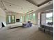 Spacious unfinished living room with fireplace, double doors, and multiple windows at 1309 Errol Green Ct, Apopka, FL 32712