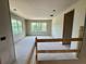 Unfinished living space showing drywall, windows overlooking trees, and a modern railing at 1309 Errol Green Ct, Apopka, FL 32712