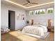 Bright, staged primary bedroom featuring a ceiling fan, modern lighting, and large windows at 1309 Errol Green Ct, Apopka, FL 32712