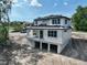 The rear exterior of the two-story house with a porch and open lower level at 1309 Errol Green Ct, Apopka, FL 32712