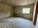 Clean room with new drywall and a window, offering a blank canvas for customization at 1309 Errol Green Ct, Apopka, FL 32712