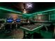 Game room features pool table, gaming stations, and themed decor at 1429 Moon Valley Dr, Champions Gate, FL 33896