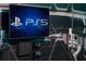 Wall-mounted TV with Playstation 5 console and controllers at 1429 Moon Valley Dr, Champions Gate, FL 33896