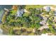 Aerial view of a neighborhood showcasing a home surrounded by lush foliage and close proximity to a lake at 7200 Grace Rd, Orlando, FL 32819