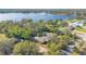 Aerial view of the neighborhood showcasing mature trees, manicured lawns and a large, scenic lake at 7200 Grace Rd, Orlando, FL 32819