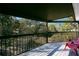 Covered back porch has two chairs and a black railing surrounding the perimeter at 7200 Grace Rd, Orlando, FL 32819