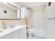 This bathroom features a double vanity, a built-in shower-tub, and updated tile flooring at 7200 Grace Rd, Orlando, FL 32819