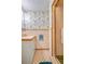 Vintage bathroom with pink tile, fern wallpaper and enclosed shower in need of renovation at 7200 Grace Rd, Orlando, FL 32819