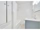 All-white bathroom featuring a tub-shower combo, white cabinets, and a stylish sink at 7200 Grace Rd, Orlando, FL 32819